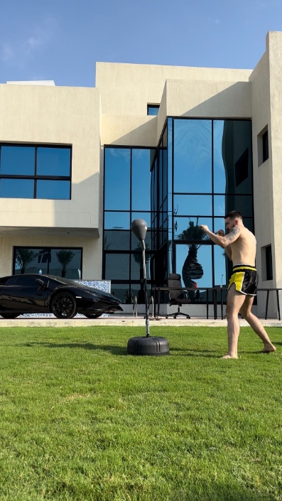 Daniel boxing in front of a villa in Dubai