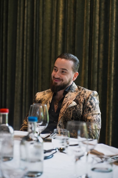 Daniel smiling at a dinner