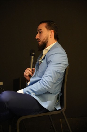 Daniel in a patterned blazer at a dinner
