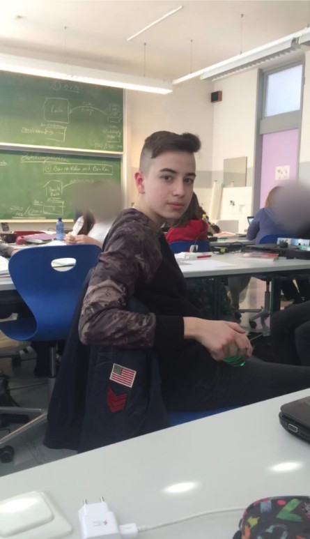 Daniel as a teenager in a classroom