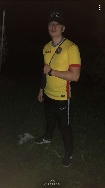 Daniel in a Romania football jersey at night